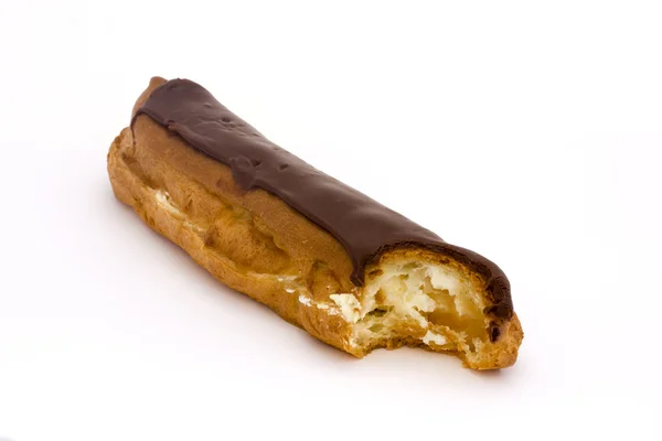 Chocolate eclaire with a bite taken — Stock Photo, Image