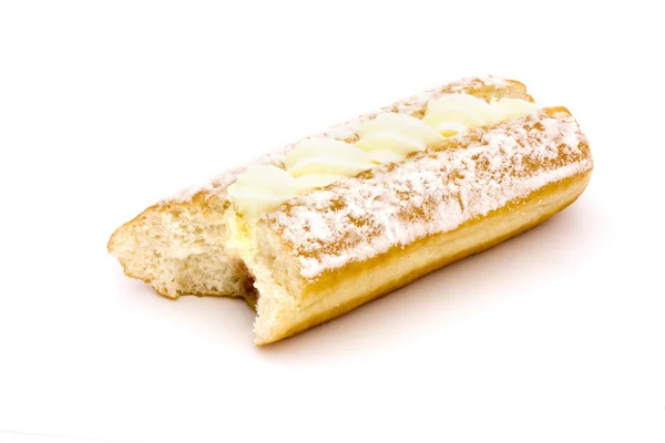 Cream cake with a bite taken over white — Stock Photo, Image