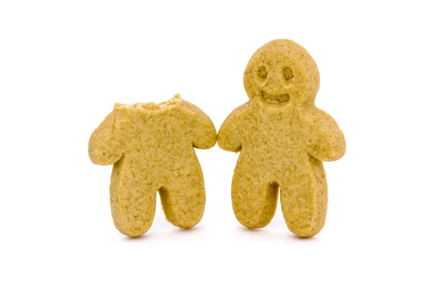 Two gingerbread men one with head bitten — Stock Photo, Image
