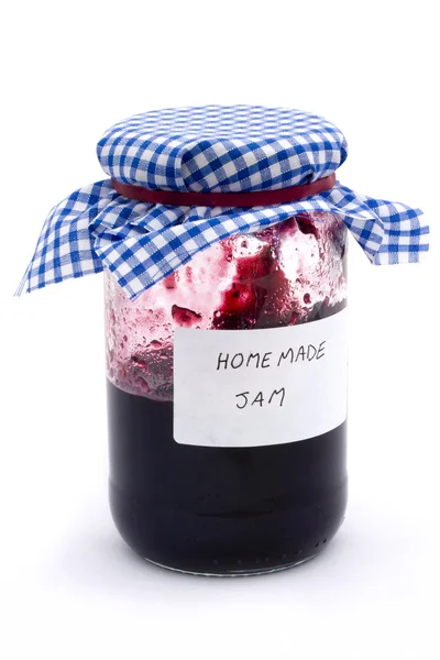 Jar of homemade jam over white — Stock Photo, Image