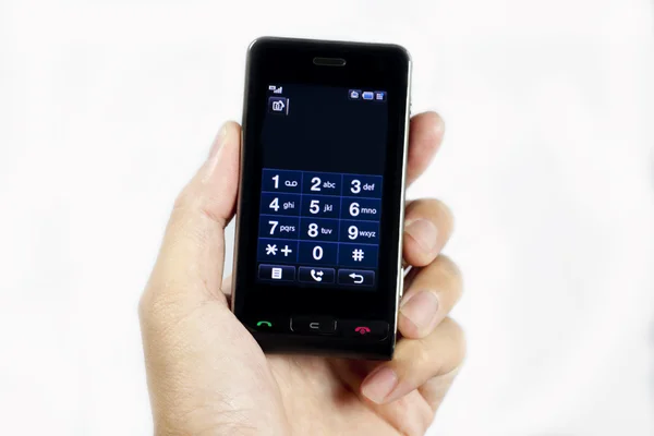Telefon komórkowy w ręku na białym tle na whi — Zdjęcie stockowe