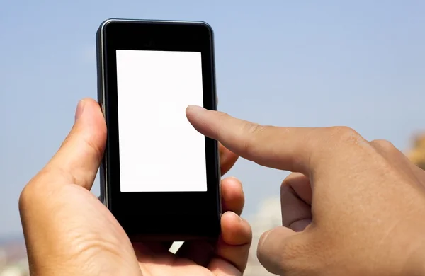 Ruka drží a touch chytrý telefon — Stock fotografie