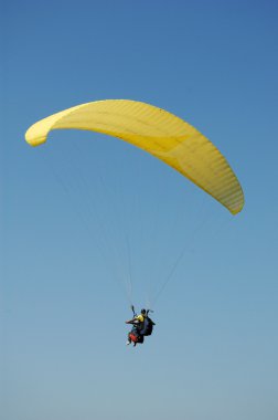 Double Paragliding flying away clipart