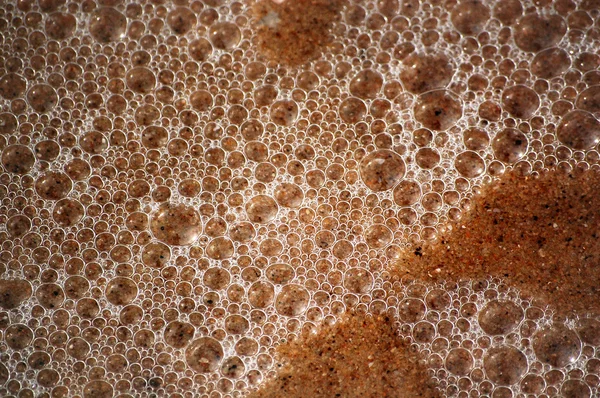 Texture di sabbia bagnata e bolle oceaniche — Foto Stock