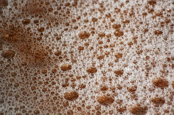 Textuur van natte zand en de oceaan bubbels — Stockfoto
