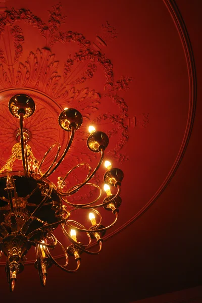 Classic chandelier on the red ceiling — Stock Photo, Image