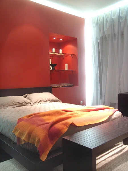 Illuminated bedroom in red colors — Stock Photo, Image