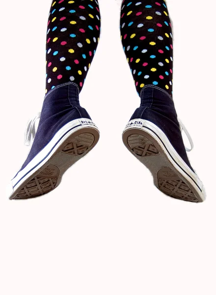 Close up of woman legs wearing a pair of sneakers — Stock Photo, Image