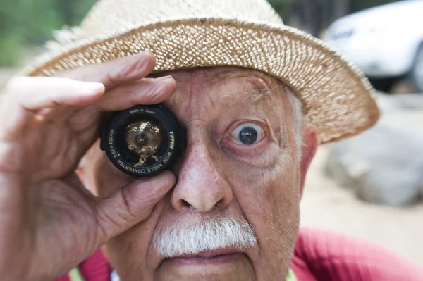 stock image person holding a vintage camera lens