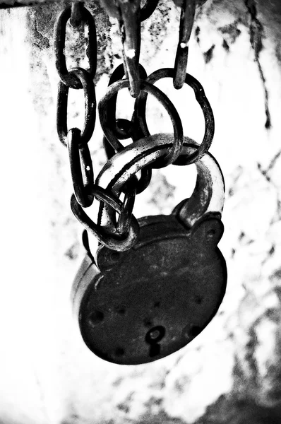 Padlock securing two metal chains Stock Image