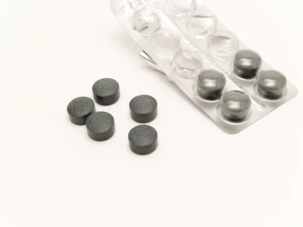 Чёрные таблетки — стоковое фото