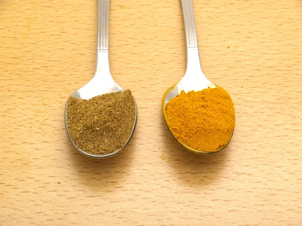 Spoons with turmeric and cumin — Stock Photo, Image