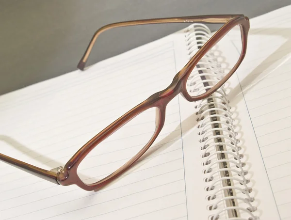 Notebook and glasses Stock Image