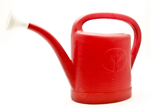Red plastic watering can — Stock Photo, Image