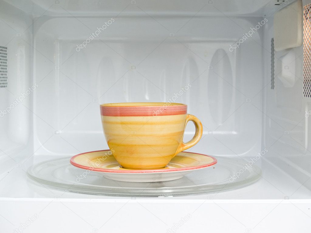 Cup of coffee in microwave