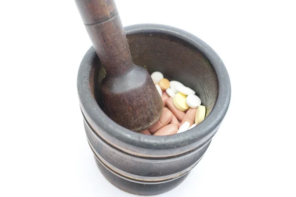 Wooden mortar with pills — Stock Photo, Image