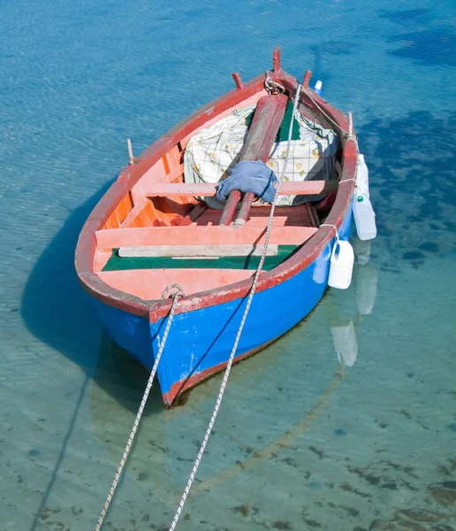 Coloured rowboat in clear sea. — Stock Photo, Image