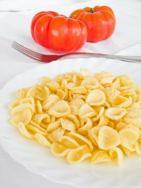 Orecchiette and tomatoes. clipart