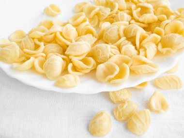 Fresh orecchiette on white dish. clipart