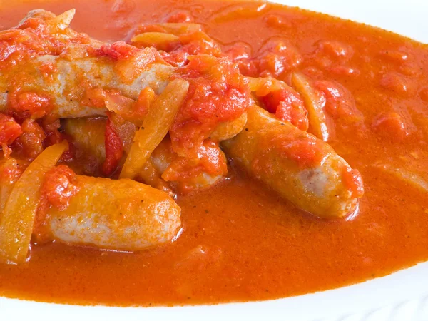 Sausages in tomato sauce. — Stock Photo, Image