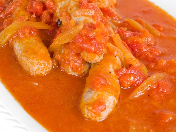 Sausages in tomato sauce. — Stock Photo, Image
