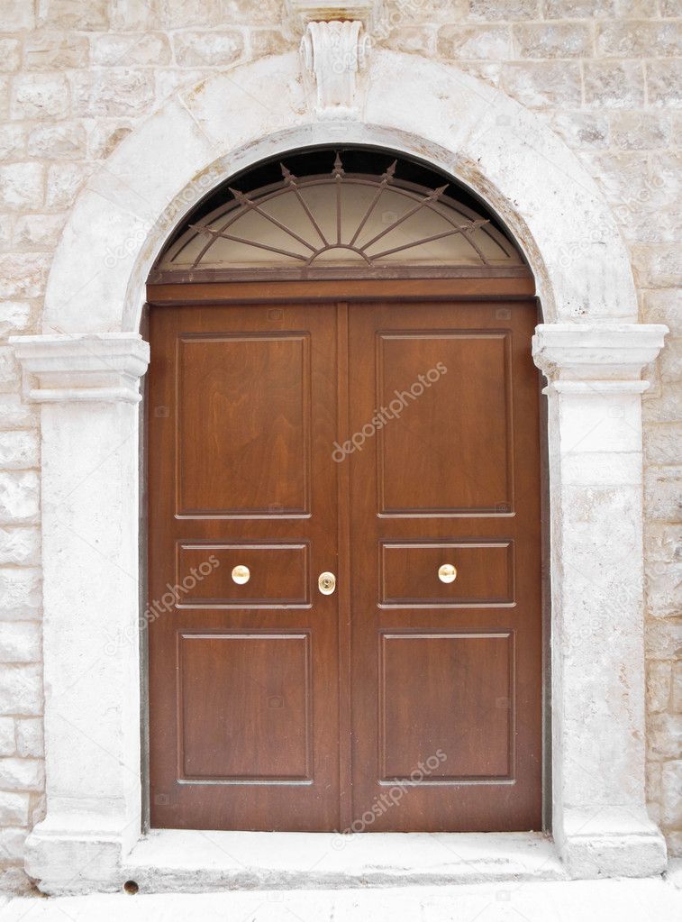 Wooden frontdoor with marble frame.