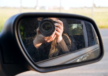 Driving mirror with photographer. clipart