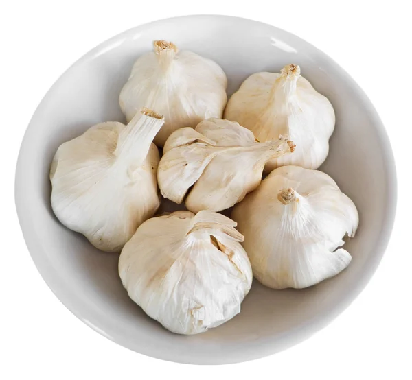 Cloves of garlic on white dish. — Stock Photo, Image