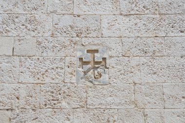 Cross carved in a wall.