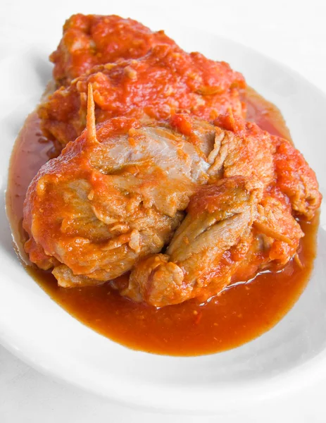 Meat roulade in tomato sauce on white dish. — Stock Photo, Image