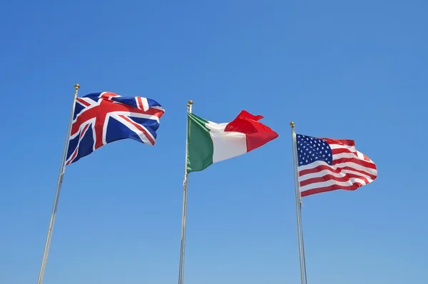 Three flags on blue sky. — Stock Photo, Image