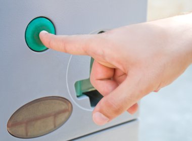 Detail of a male hand pressing a green button. clipart