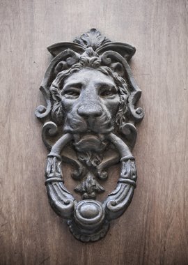 Doorknocker on allwood door. clipart