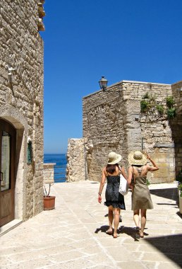 Tourists walking in Giovinazzo. Apulia. clipart