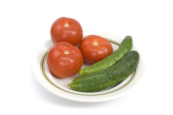 Tomatoes and cucumbers on a plate — Stock Photo, Image