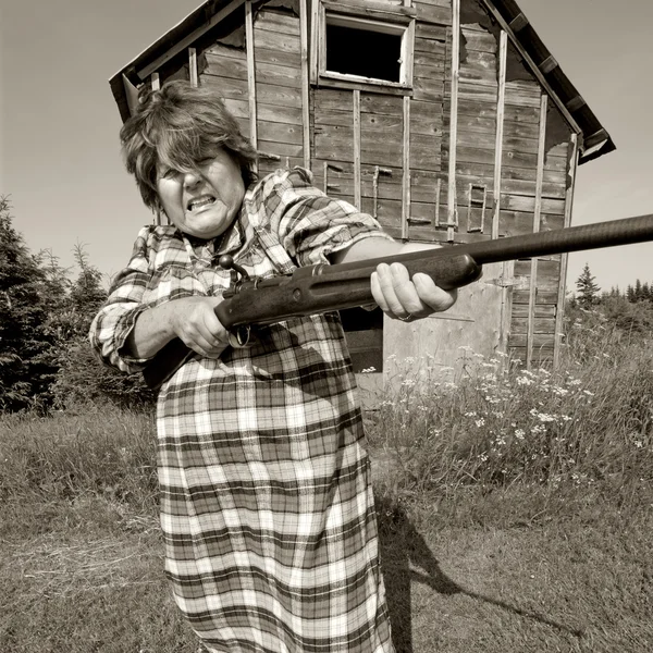 Angry woman with big gun — Stock Photo, Image