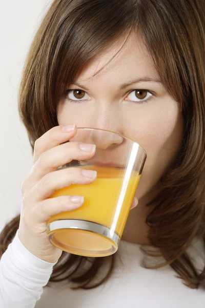 Drinking orange juice — Stock Photo, Image