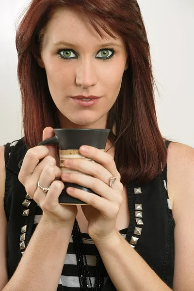 Beautiful female with green eyes drinking coffee — Stock Photo, Image
