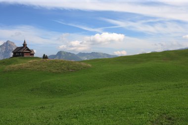 Church on a mountain meadow clipart