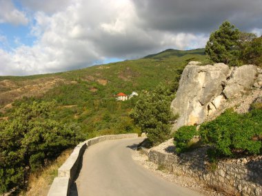 Mountain landscape with serpentine road. clipart