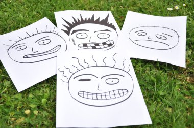 Facial expressions drawn on paper clipart