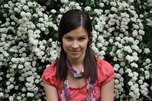 Smiling girl sitting in the park — Stock Photo, Image