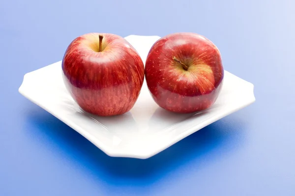 Apples in white plate — Stock Photo, Image