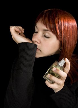 Girl smelling parfume from her hand clipart