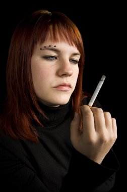 Girl watching her cigarette clipart