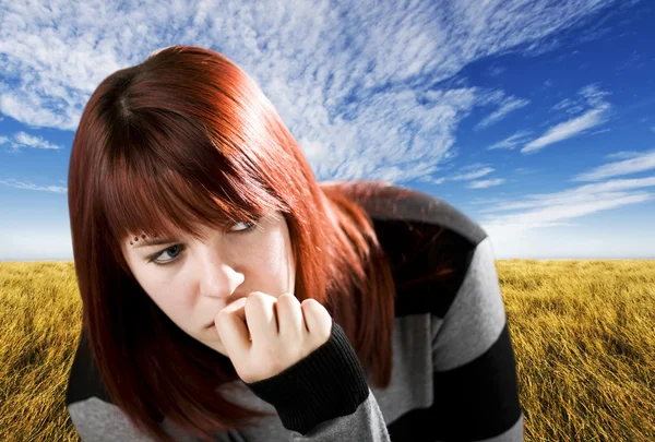 Pensive redhead girl biting nail — Stock Photo, Image