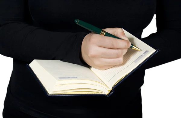 Γυναικείο χέρι να γράφει σε ένα σημειωματάριο — Φωτογραφία Αρχείου