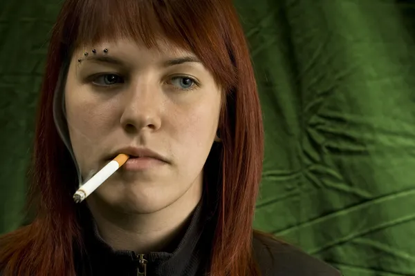 Girl smoking cigarette and bored — Stock Photo, Image
