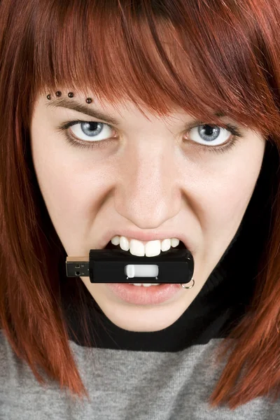 Aggresive girl biting memory stick — Stock Photo, Image