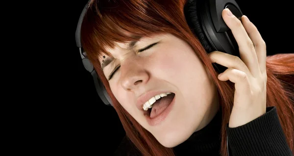 Cute redhead enjoying music — Stock Photo, Image